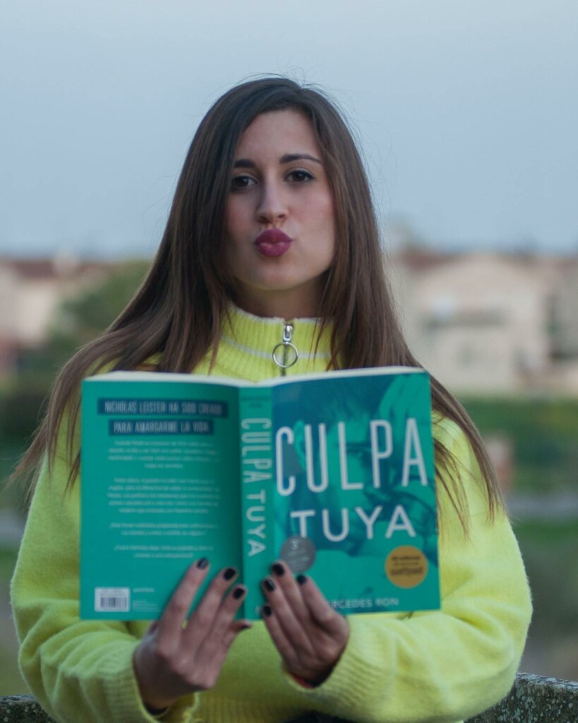 Mercedes Ron posando junto a su novela Culpa Tuya